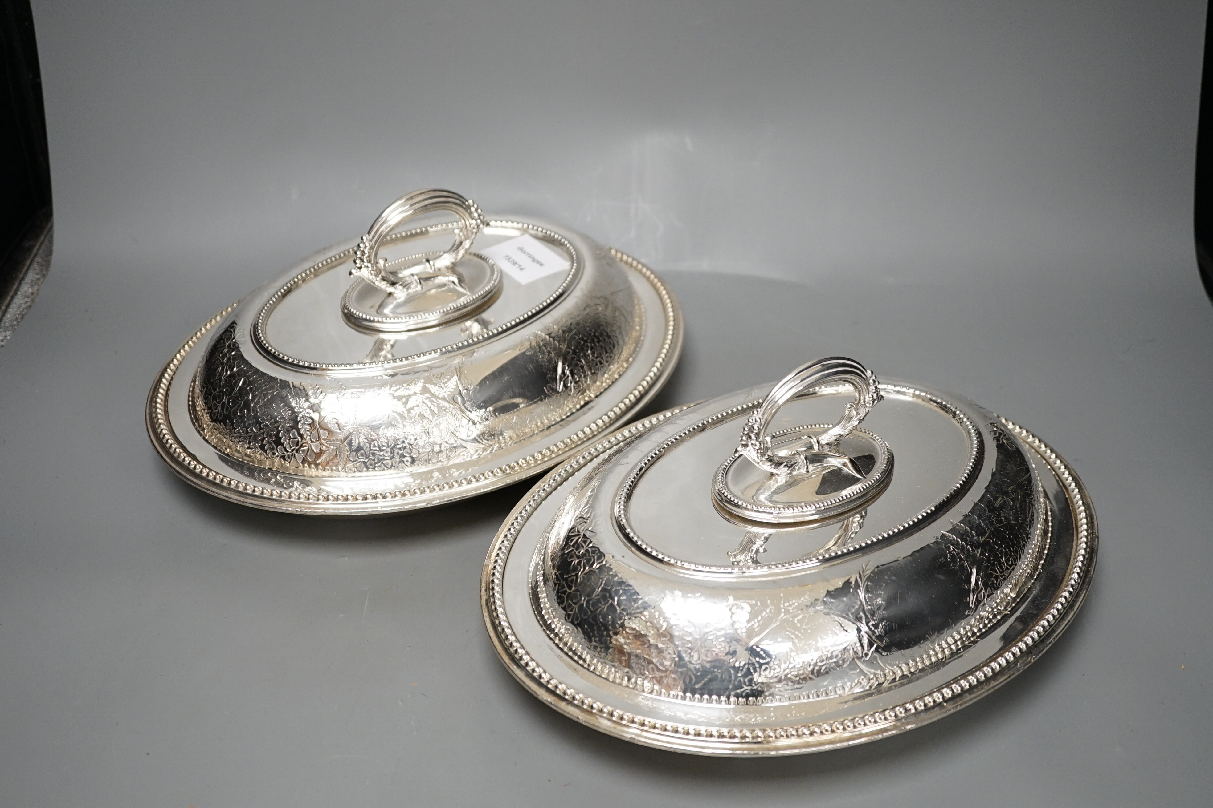 A pair of Edwardian plated engraved oval entree dishes and covers